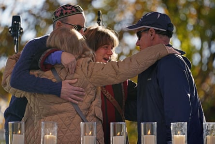 Mourners hug last year after lighting a candle in memory of Melvin Wax, one of 11 Jewish worshippers killed at the Tree of Life synagogue in Pittsburgh.