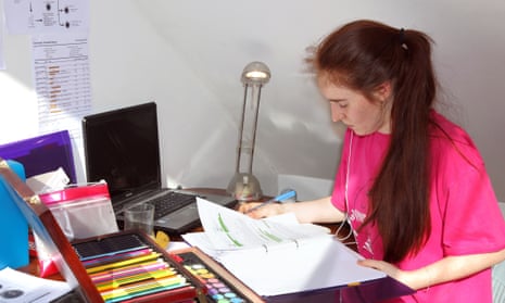 A student revising for an exam at her desk.