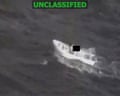 Screenshot of video footage from the US military showing a boat about to be bombed in the Pacific Ocean.