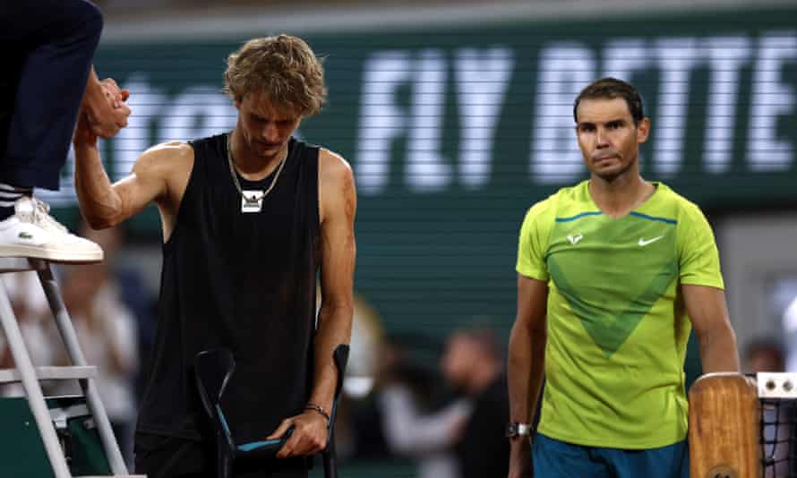 Alexander Zverev shakes hands with the referee after being forced to retire