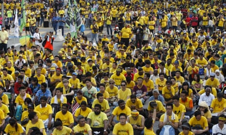 Activists from the coalition for clean and fair elections, or Bersih, gather on a main road in Kuala Lumpur for a second day on Sunday.
