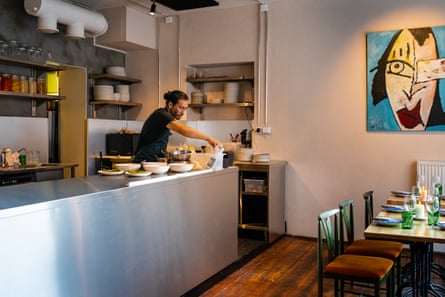 Inside a restaurant with a chef preparing service