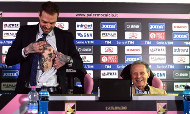 Paul Baccaglini (L) new President of Palermo shows a tattoo displaying a club logo as former president Maurizio Zamparini looks on.