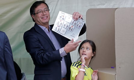 Colombian presidential candidate Gustavo Petro, accompanied by his daughter Antonella, votes in Bogota.