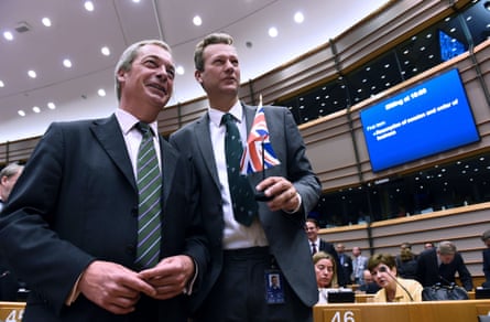 Farage and Gill posing for a photo, with Gill holding a UK flag