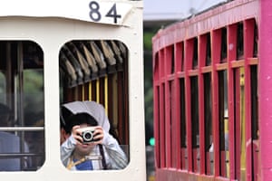 A child takes photos from a tram