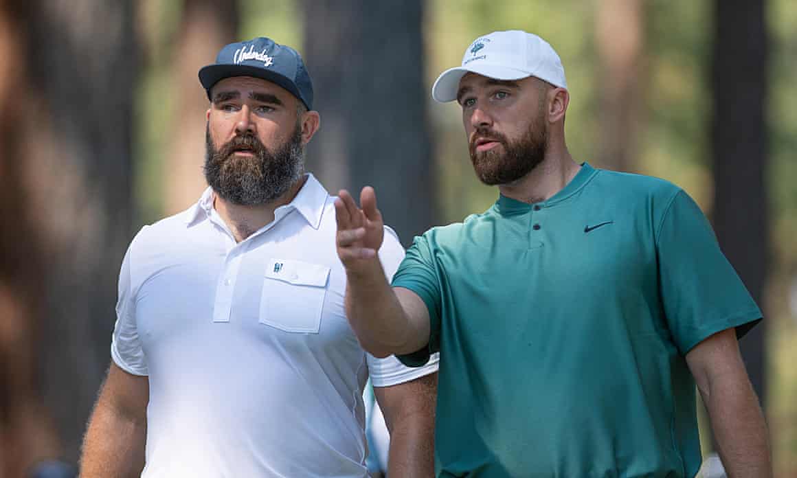 Travis Kelce, wearing a green shift and white cap, and Jason Kelce, wearing a white polo and blue cap, are photographed during the ACC Celebrity Golf Championship presented by American Century Investments at Edgewood Tahoe Golf Course in Stateline, Nevada