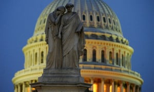 A statue representing Grief lays her covered face on the shoulder of the statue representing History on the Peace Monument near the US Capitol.