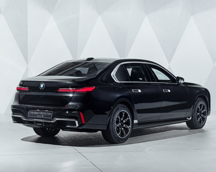 A black BMW i7 Drive in a grey panelled showroom