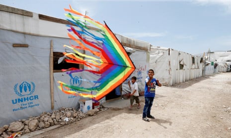 Syrian refugee boys fly a kite inside a Syrian refugee camp in Bekaa valley, Lebanon