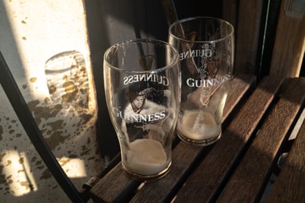 Two empty pints of Guinness on the outside bar area at the Grapes public house on October 12, 2025 in Limehouse area of London