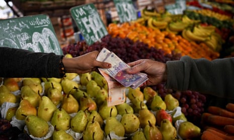 A man buys fruit and vegetables at the central market in Buenos Aires, Argentina