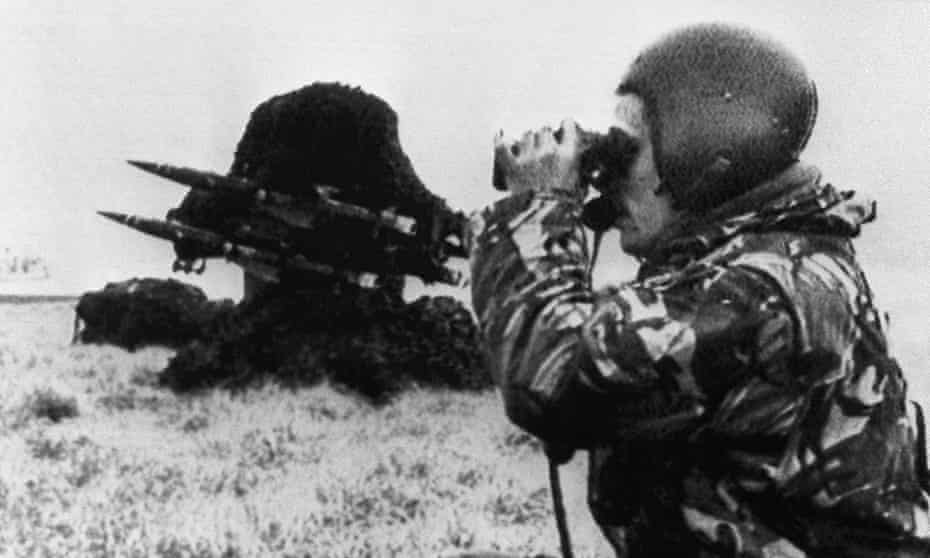 A British soldier looks through binoculars past a Rapier missile air defense battery in the Falklands on 25 May 1982. Argentina has protested at exercising involving Rapier missiles this month.