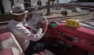 A taxi driver reads the newspaper
