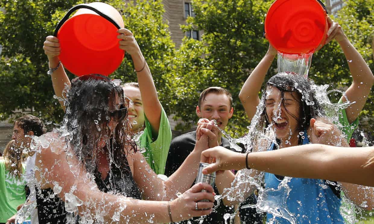 FILE - In this Aug. 7, 2014, file photo, two women get doused during the ice bucket challenge at Boston’s Copley Square to raise funds and awareness for ALS. The ALS Association says money raised through the challenge helped fund a project that has discovered a gene linked to the disease. (AP Photo/Elise Amendola, File)