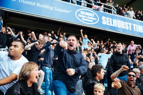Millwall fans celebrate a goal in stands.