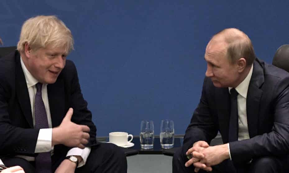 Boris Johnson and Russia’s president Vladimir Putin talk during a meeting on the sidelines of an international summit on Libya.