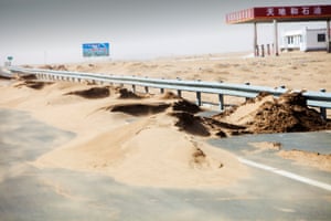 Inner Mongolia, China: Creeping desertification. Sand dunes spreading across the highway in Inner Mongolia, northern China.