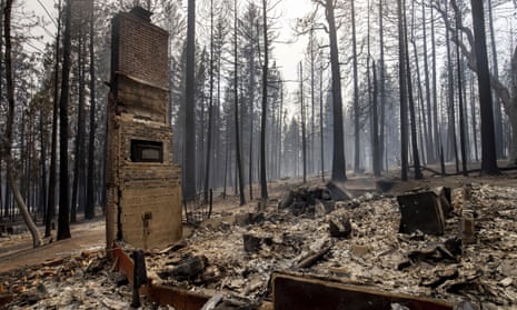 A chimney is left standing after a property was destroyed by the Caldor fire in Grizzly Flats, California.