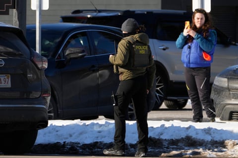 A woman films a Homeland Security Investigations agent