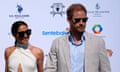 Britain's Prince Harry, right, and wife Meghan Markle, Duchess of Sussex