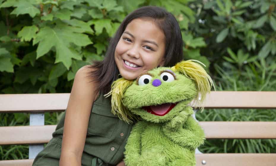 Ten-year-old Salia Woodbury, whose parents are in recovery, with the Sesame Street character Karli.