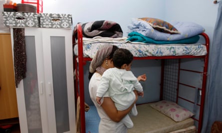 An Uzbek woman stands in her bedroom at the City of Hope women’s shelter in Dubai.