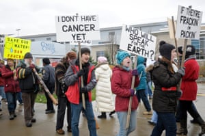 Anti-fracking protestors carry signs while protesting in front of The Covelli Center near downtown Youngstown, Ohio, where the Youngstown Ohio Utica &amp; Natural Gas Conference &amp; Expo took place.