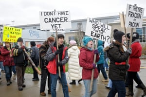 Anti-fracking protestors carry signs while protesting in front of The Covelli Center near downtown Youngstown, Ohio, where the Youngstown Ohio Utica & Natural Gas Conference & Expo took place.