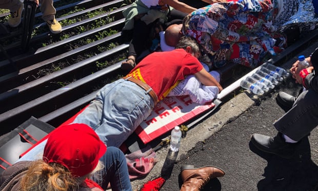 Activists lay chained to a cattle grate blocking a road at the base of Hawaii’s tallest mountain on Monday.