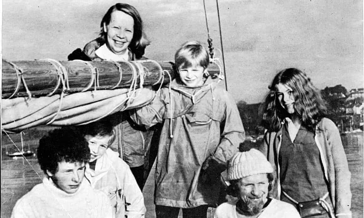 The five-strong family pose on a boat