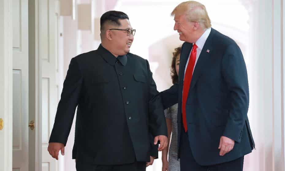 Donald Trump and Kim Jong-un walk to the summit at the Capella hotel on Sentsoa island in Singapore on 12 June. 
