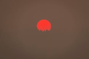 Tinted orange by wildfire smoke from Oregon and southern Washington, the sun sets behind a hill on September 9, 2020 in Kalama, Washington. Gov. Jay Inslee declared a statewide emergency as blazes continue to spread across the state.