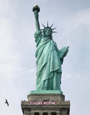 'Refugees welcome' banner draped on Statue of Liberty