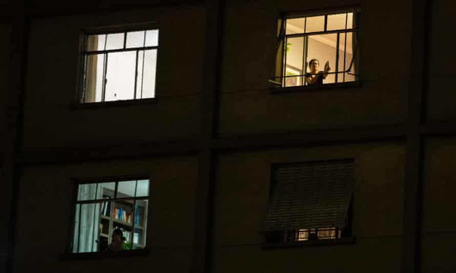 Protesters stand on their windows making noise with pots and pans (Panelaco) against President of Brazil Jair Bolsonaro
