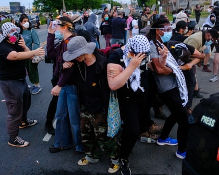 A group of protesters retreats aft national agents sprayed them pinch a chemic supplier extracurricular Delaney Hall.