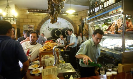 Busy interior of Bodega Santa Cruz tapas bar in Seville, Spain