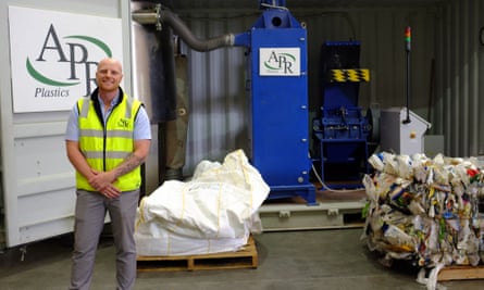 Logan Thorpe alongside a plastic shredder at APR Plastics.
