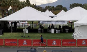 A person jogs past a vaccination site for the coronavirus disease at the University of Arizona in Tucson, Arizona.