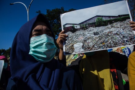 Activists campaign against imported plastic waste near the US consulate general office in Surabaya, in Indonesia’s East Java province