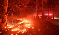 Burning embers cover the ground as firefighters battle against bushfires around the town of Nowra, New South Wales on December 31, 2019. 