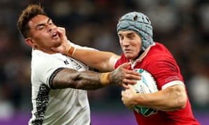 Wales' Jonathan Davies hands off Fiji's Jale Vatubua to set up Josh Adams' third try.