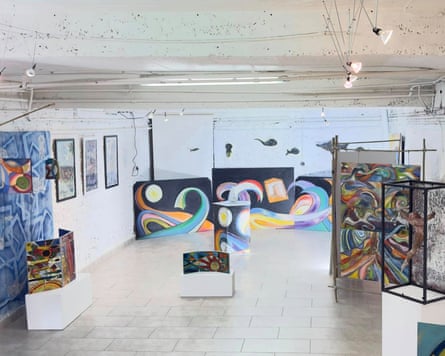 Interior of a gallery with paintings.