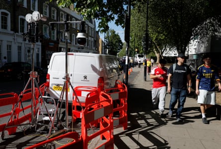 Arsenal fans walk down Hornsey Road on their way to the ground past facial recognition cameras set up by the Met Police