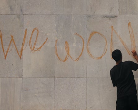 A protester writes ‘We won’ on the parliament building