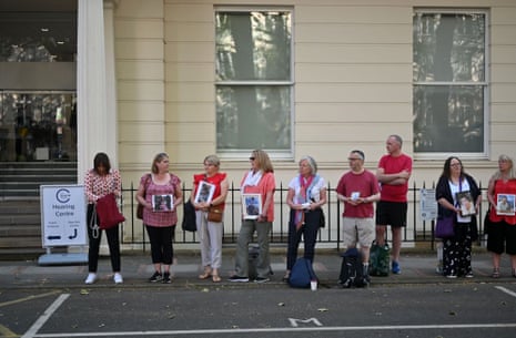 Members of the Covid-19 Bereaved Families for Justice hold photos of relatives who died during the pandemic outside the building in London where the Covid inquiry will start its evidence-gathering proceedings this morning.
