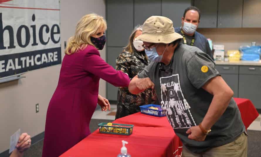 The US first lady, Jill Biden, elbow bumps a man