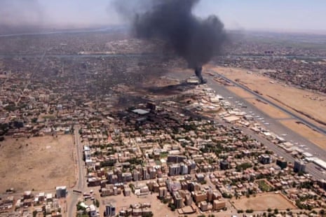 An aerial view of black smoke rising above the Khartoum airport amid ongoing battles between the forces of two rival generals.