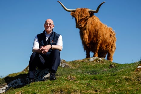 John Swinney with Highland cow Cairistiona at High Airyolland farm today.