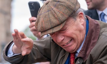 Nigel Farage reacts after something is thrown towards him